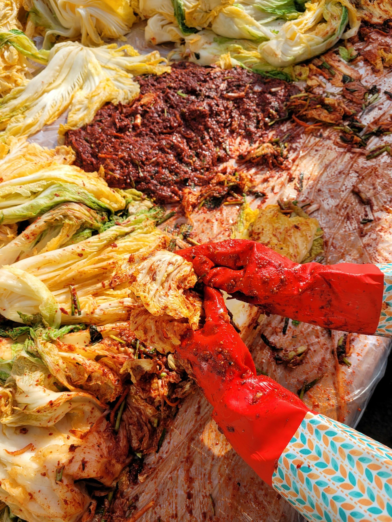 김치를 담그려고 쌓아 둔 재료를 칼로 손질하는 모습